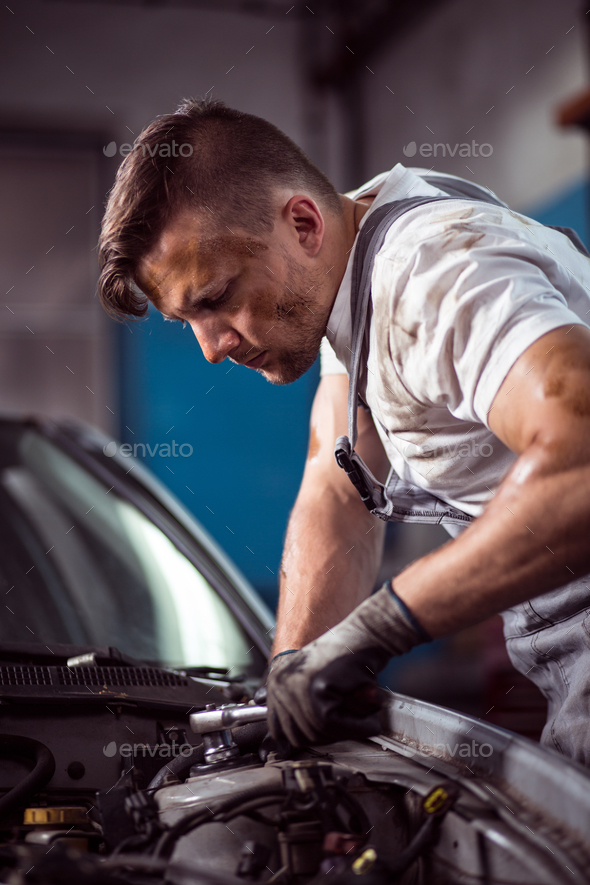 Handsome mechanic working Stock Photo by bialasiewicz PhotoDune